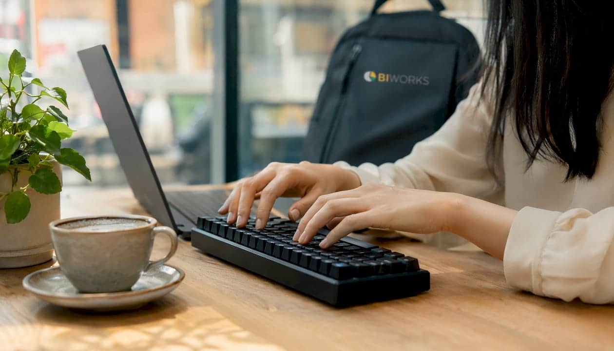 Les doigts sur le clavier, smartphone et carte mémoire à portée de main